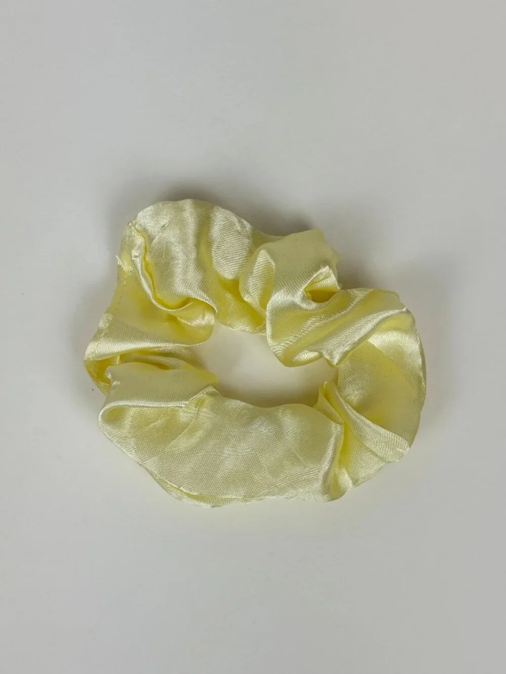 Pale yellow satin scrunchie. New without tags. Never used. Unbranded